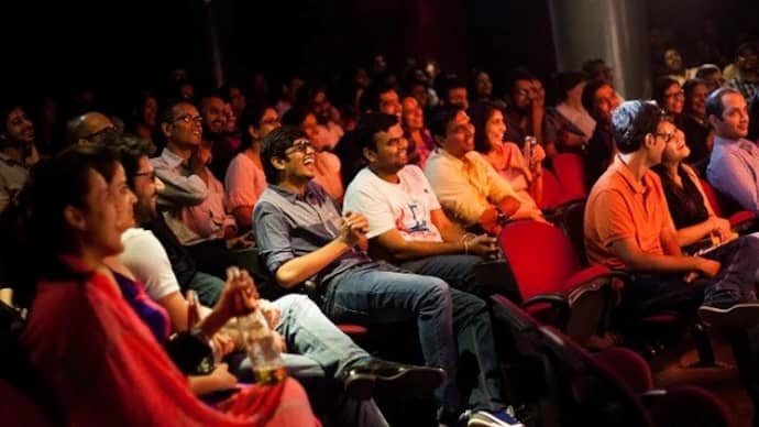 An audience watching a live performance from theater seats